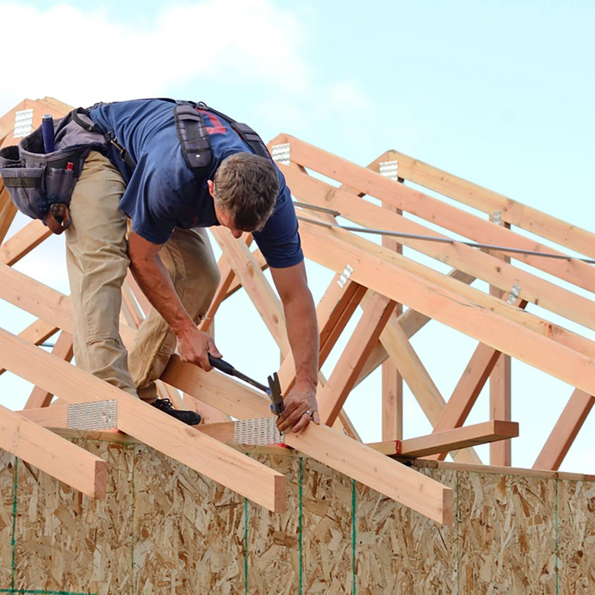 a contractor installing a roofing truss